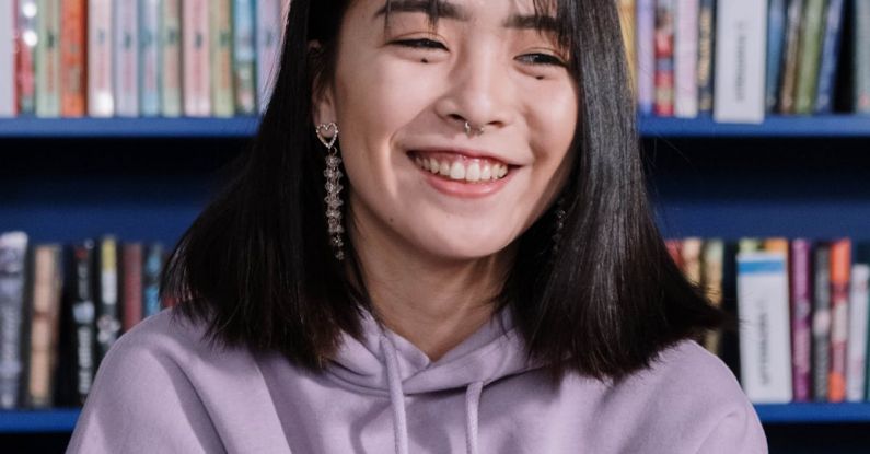 Managing Gen Z - A Young Woman in Purple Hoodie Smiling