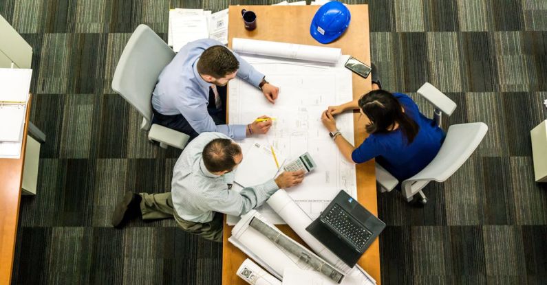 Change Management - Three People Sitting Beside Table