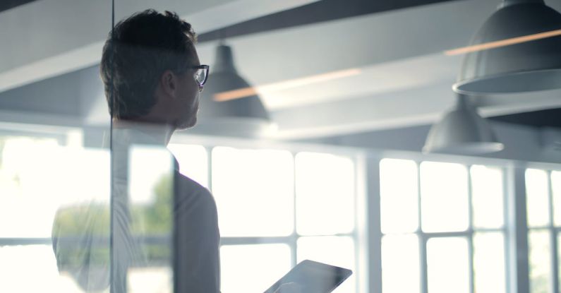 Inspirational Leader - Formal man with tablet giving presentation in office