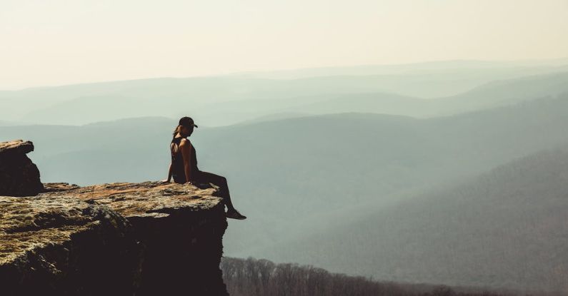 Reputation Risk - Woman Sitting on Edge of Rock Formation