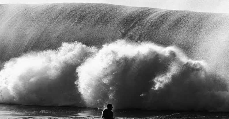 Compliance Risk - Silhouette of anonymous man near wave