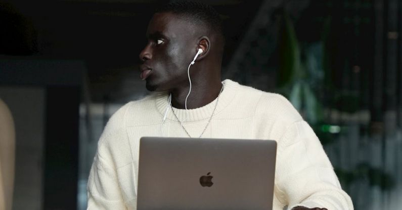 Employee Productivity - Man Sitting at Desk with Laptop