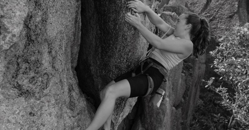 Agile Methodology - A black and white photo of a woman climbing