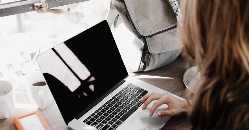 Productive Meetings - Close-up Photography of Woman Sitting Beside Table While Using Macbook