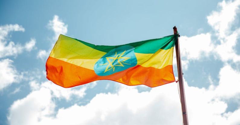 Fair Labor - National colorful flag of Ethiopia under cloudy sky