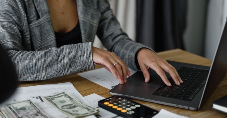 Ethics Profitability - A Woman in Plaid Blazer Using Her Laptop