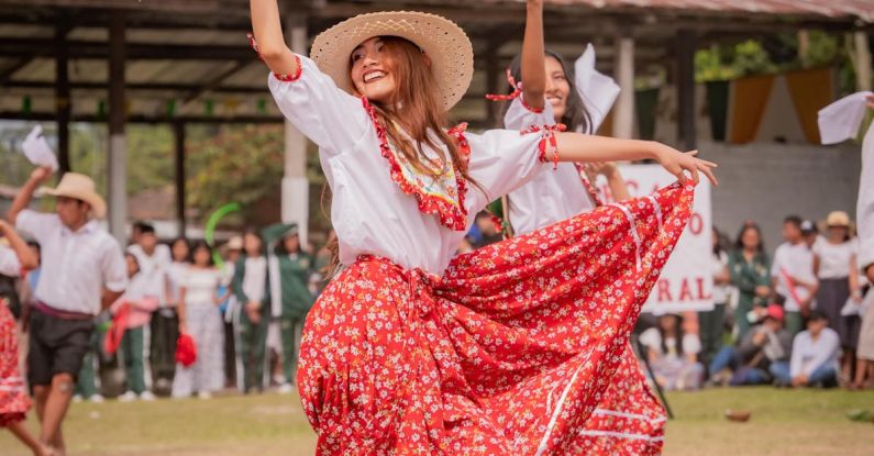 Ethical Culture - A woman in a red and white dress is dancing