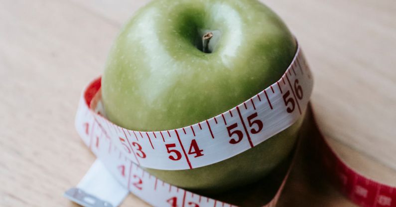 Product-market Fit - Green apple with measuring tape on table in kitchen