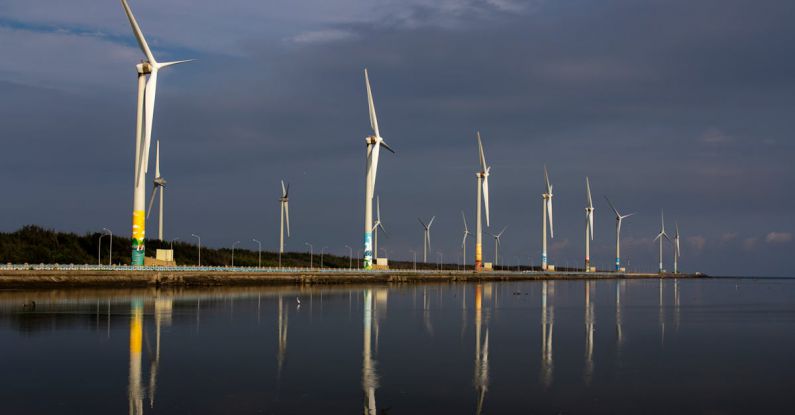 Sustainable Startup - Wind turbines are reflected in the water