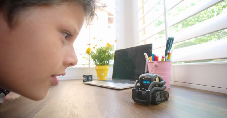 User-centric Innovation - Close Up Photo of Kid Looking at a Miniature Toy Robot