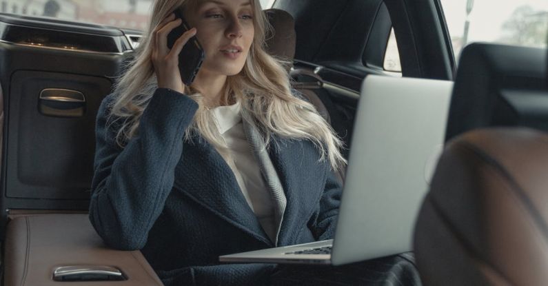 Resilient Leader - Woman in Gray Business Suit Sitting In A Luxurious Car
