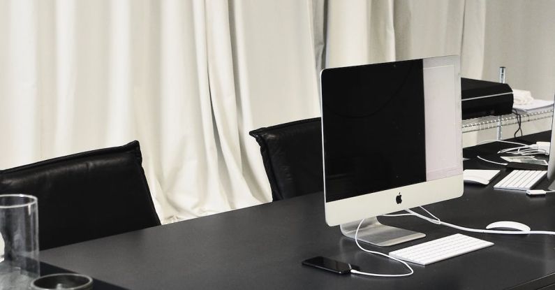 Innovation Failures - Black and white of contemporary computer placed on table in simple contemporary workplace of office